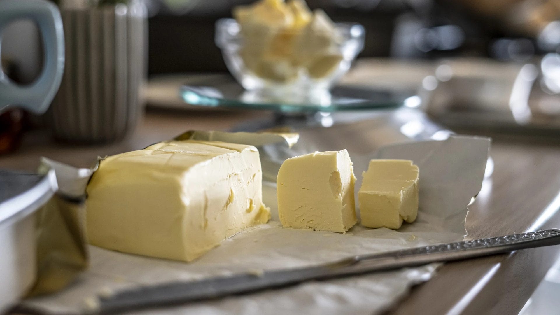 Slices Of Butter On A Wooden Table With A Knife